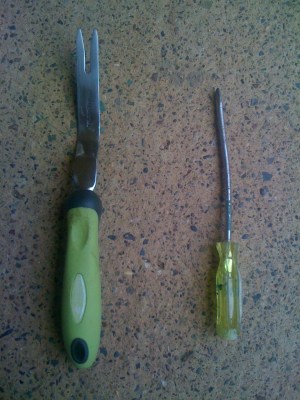 The right tool for pulling weeds and the wrong tool (a screwdriver)