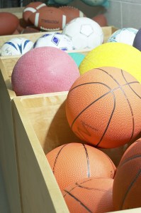 Boxes of different balls, basketballs, volleyballs, footballs