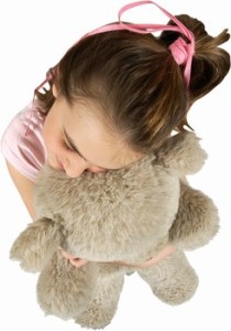 Girl hugging a teddy bear
